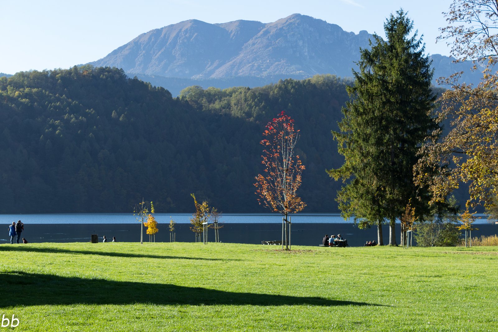 Lake Levico in autumn with the colours of the woods